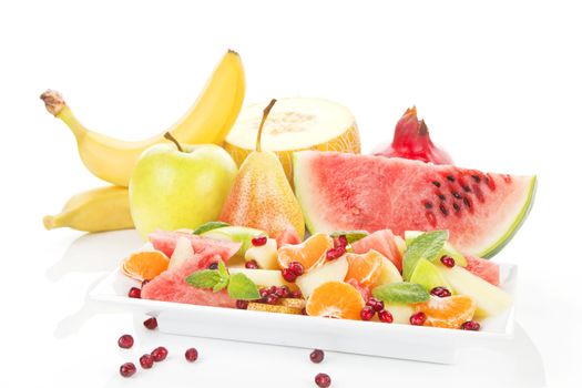 Fresh fruits and fresh fruit salad isolated on white. Summer background.