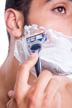 Man shaving his face over white background