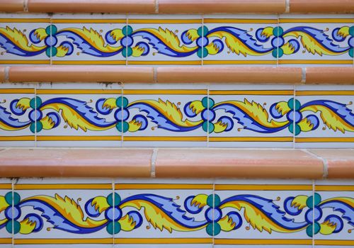 Detail of staircase with patterned ceramic tiles and terracotta.