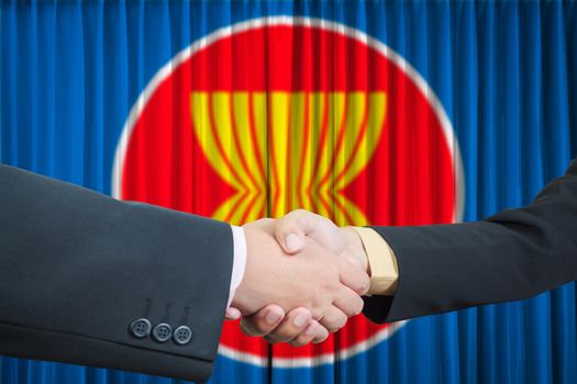 ASEAN Economic Community in businessman handshake