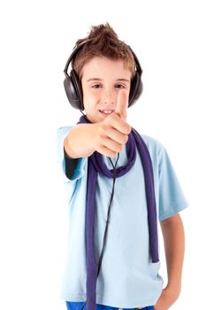 Cute little boy enjoying music using headphones and showing thumbs up over white background