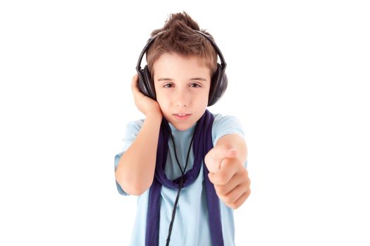 Cute little boy enjoying music using headphones and showing thumbs up over white background