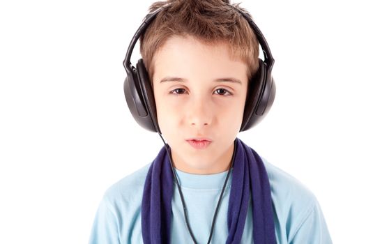 Cute little boy enjoying music using headphones over white background