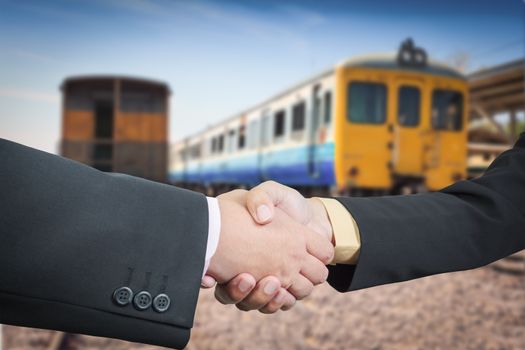 Businessman handshake with train transportation logistic background