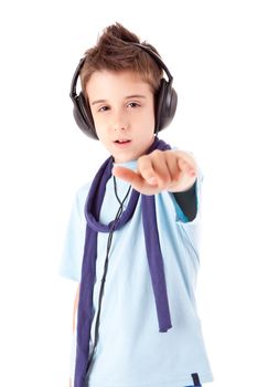 Cute little boy enjoying music using headphones over white background