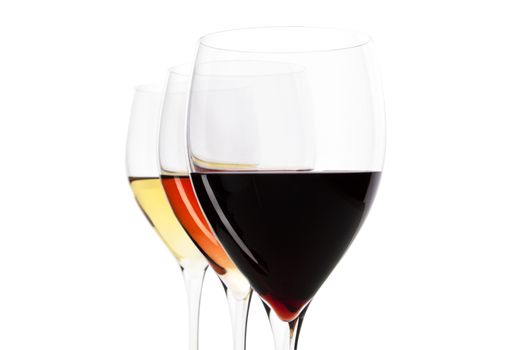 Three elegant crystal wine glasses with red, rose and white wine isolated on white background with clipping path.