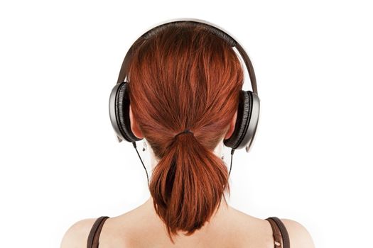 Attractive female with red hair and a tail with headphones isolated on white with clipping path. Back view.