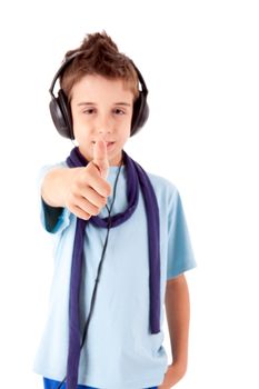 Cute little boy enjoying music using headphones and showing thumbs up over white background