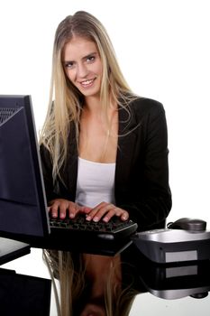 Pretty blond office secretary lady smiling while she types on keyboard on her desk