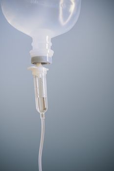 Infusion bottle with saline solution for patient in hospital room