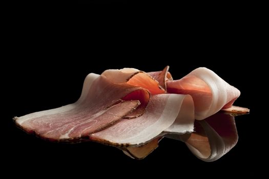 Delicious bacon slices isolated on black background. Food concept. Meat