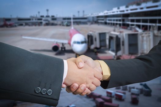Businessman handshake with air plane transportation logistic background