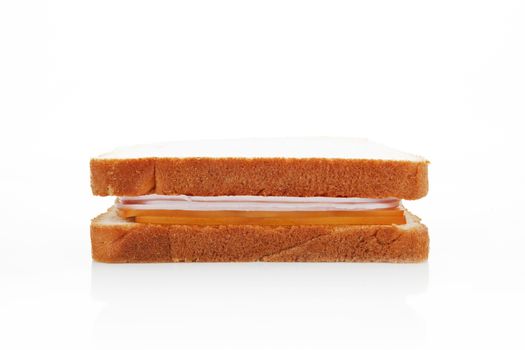 Ham and cheese sandwich isolated on white background, side view.