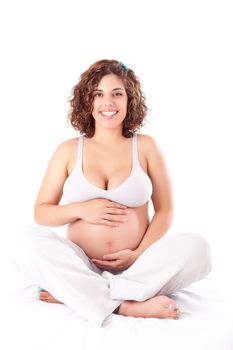 Beautiful pregnant woman showing her good shape over white background