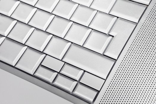 Silver keyboard detail with empty buttons.