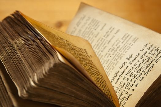 Old antique book open on wooden background.