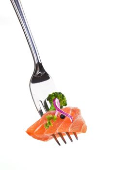 Salmon piece with broccoli, onion, pepper corn and herb arranged on fork isolated on white background.