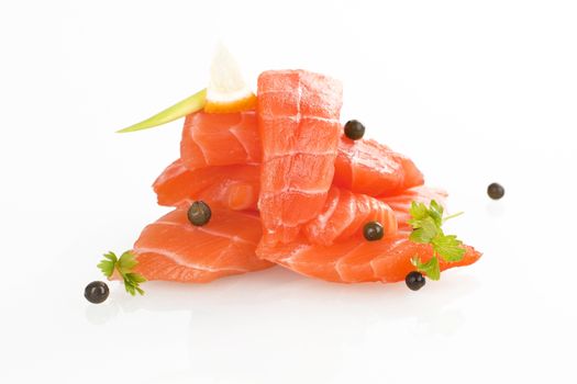 Sashimi sushi. Raw salmon pieces arranged on white background. 