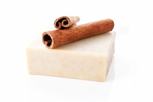 Square cinnamon soap bar with cinnamon isolated on white background.