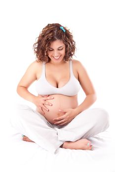 Beautiful pregnant woman showing her good shape over white background