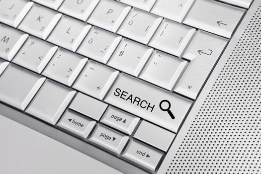 Silver keyboard with a search icon and text SEARCH on a key. Search concept.