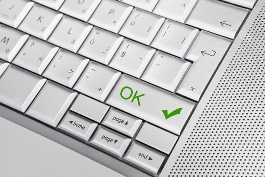 Silver keyboard with OK icon and text Ok on a key. Business concept