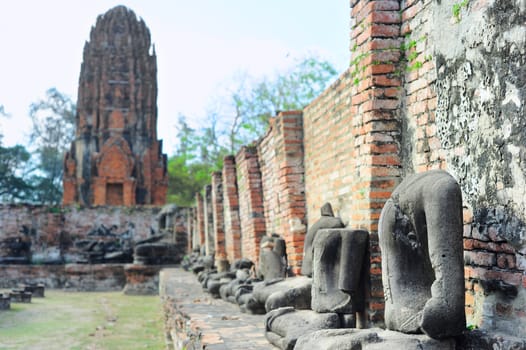 A row of Buddha statues without head in Ayutthaya historical park, Ayutthaya , Thailand 