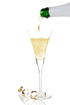 Pouring golden champagne into a glass isolated on white. Luxury celebration concept.