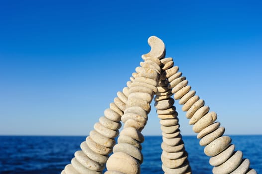 Pyramidal group of small pebbles in the balance on the seashore