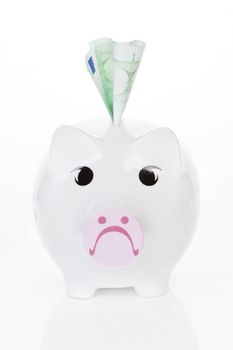 Sad piggy bank with hundred euro note isolated on white background. Savings concept.