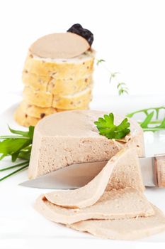 Delicious pate on white plate. Pastry in background. Culinary french gourmet eating.