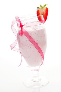 Luxurious strawberry milkshake smoothie with garnish isolated on white background. Delicious summer drinks.