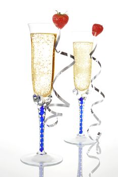 Two champagne glasses decorated with strawberries. Luxury celebration concept.