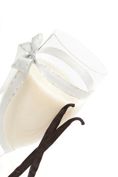 Delicious vanilla milkshake, yogurt smoothie with vanilla sticks isolated on white background. Culinary summer drinks.