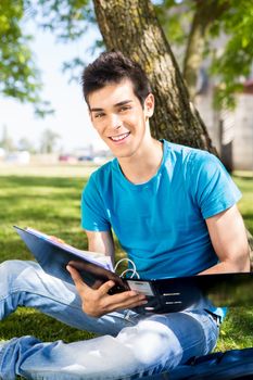 Young student studying at the school garden