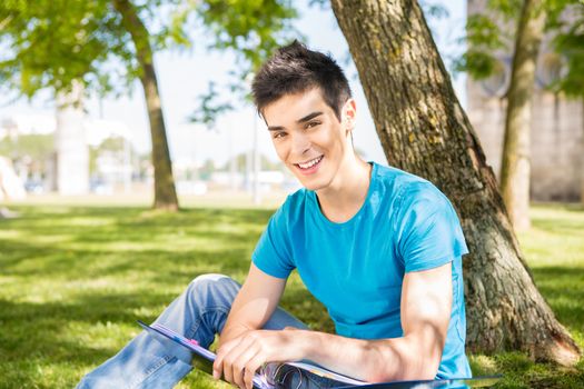 Young student studying at the school garden