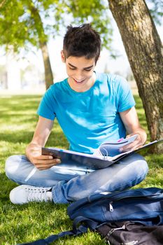 Young student studying at the school garden