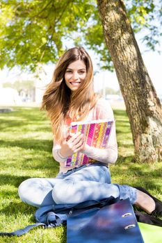 Young student studying at the school garden