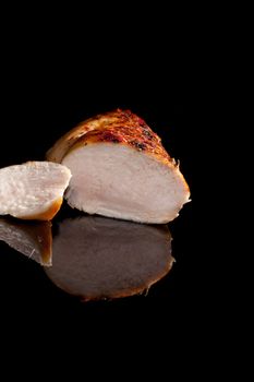 Luxurious juicy chicken steak cross section isolated on black background. Culinary cooking.