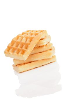 Delicious waffles pile isolated on white background with reflection. Culinary traditional sweet dessert.