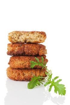 Delicious veggie burger patty tower with fresh arugula herb isolated on white background. Culinary vegetarian food.