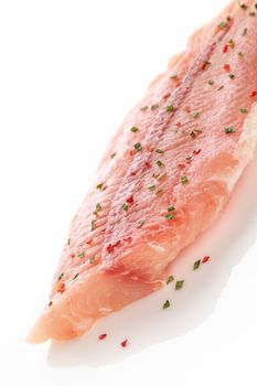 Raw fish fillet with herbs isolated on white background. Culinary seafood eating.