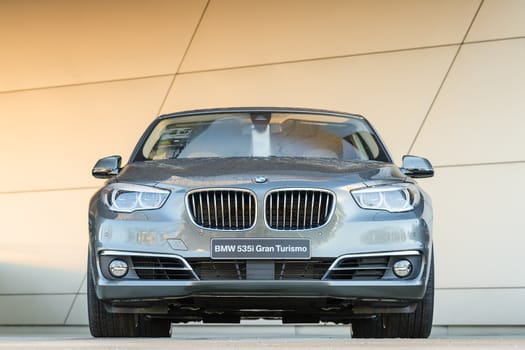 MUNICH, GERMANY - DECEMBER 27, 2013: New modern model of BMW 535i Gran Turismo family class liftback. Wet after the rain grey metallic car.