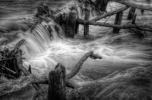 Nice wilderness weir on the river, black and white