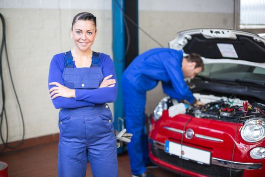 Car mechanic posing in garage