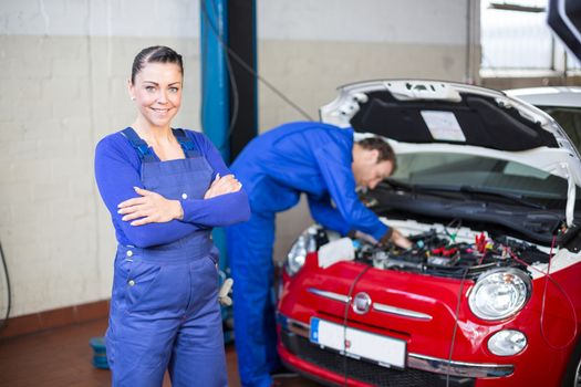 Car mechanic posing in garage