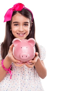 Young girl holding a piggy bank over white background