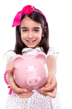 Young girl holding a piggy bank over white background