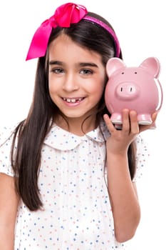 Young girl holding a piggy bank over white background
