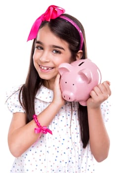 Young girl holding a piggy bank over white background